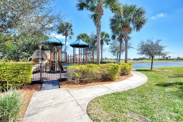 community playground with a yard and a water view