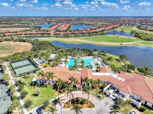 birds eye view of property featuring golf course view and a water view