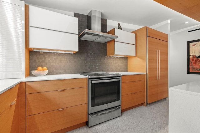 kitchen with backsplash, stainless steel range with electric cooktop, and wall chimney exhaust hood