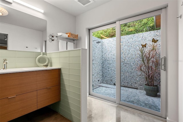 bathroom with tile walls and vanity