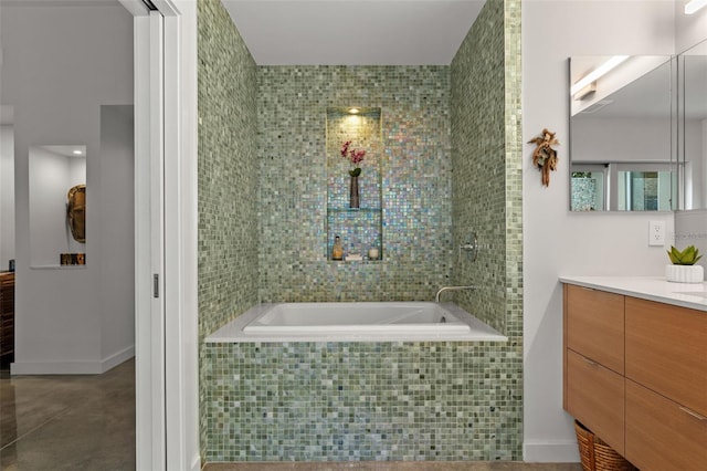 bathroom with vanity and tiled bath