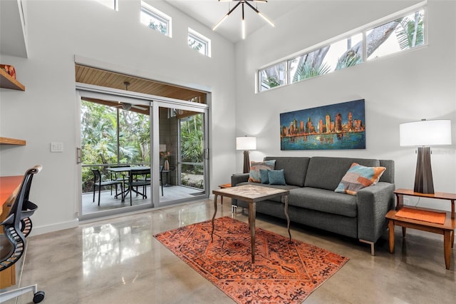 living room featuring a chandelier and a high ceiling