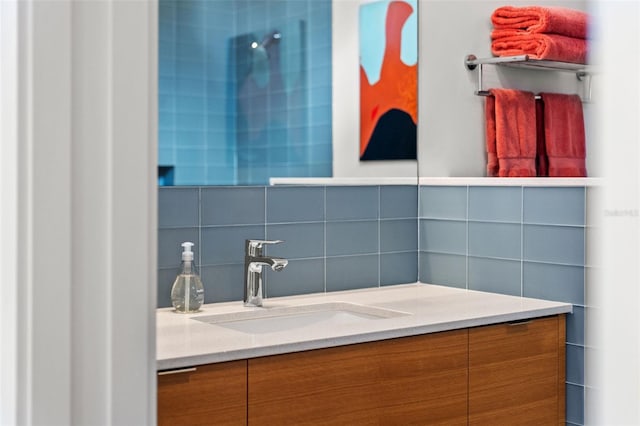 bathroom featuring vanity and tasteful backsplash