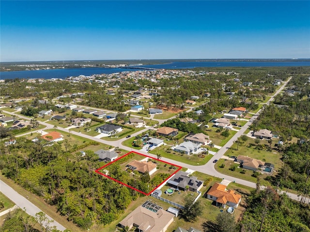 birds eye view of property with a water view and a residential view