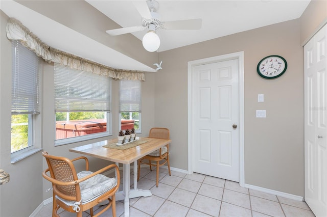 dining area featuring baseboards, ceiling fan, light tile patterned flooring, and a healthy amount of sunlight