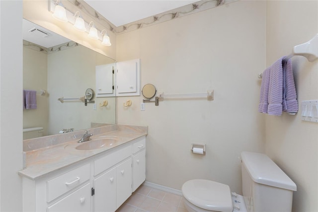 bathroom with toilet, visible vents, baseboards, vanity, and tile patterned floors