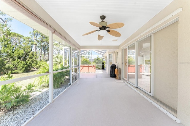 unfurnished sunroom with a ceiling fan