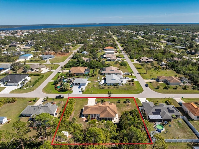 drone / aerial view featuring a residential view and a water view