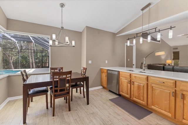 4050 Rock Creek Dr, Port Charlotte, FL 33948 - kitchen featuring lofted ceiling, light countertops, stainless steel dishwasher, and decorative light fixtures