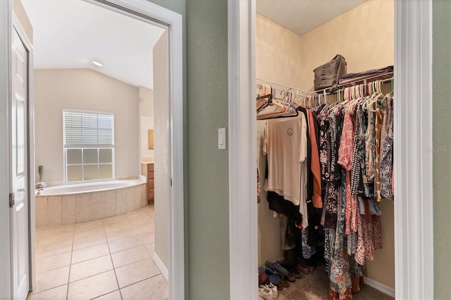 4050 Rock Creek Dr, Port Charlotte, FL 33948 - walk in closet with light tile patterned flooring and vaulted ceiling