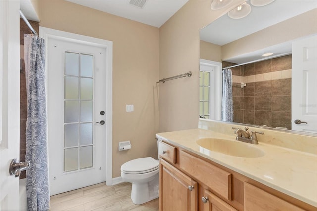 4050 Rock Creek Dr, Port Charlotte, FL 33948 - full bath with toilet, wood finished floors, visible vents, vanity, and baseboards