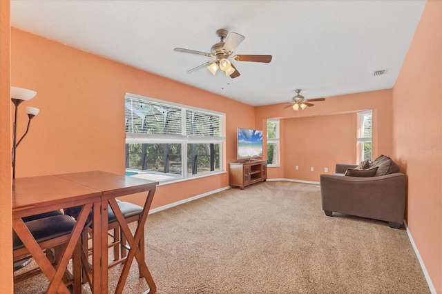 4050 Rock Creek Dr, Port Charlotte, FL 33948 - carpeted living area with plenty of natural light, visible vents, ceiling fan, and baseboards