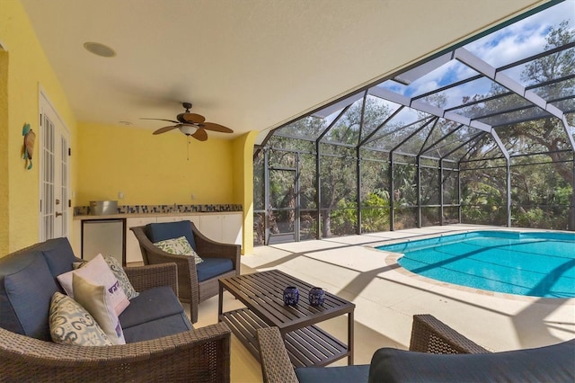 4050 Rock Creek Dr, Port Charlotte, FL 33948 - outdoor pool featuring an outdoor kitchen, an outdoor hangout area, a ceiling fan, a patio area, and a lanai