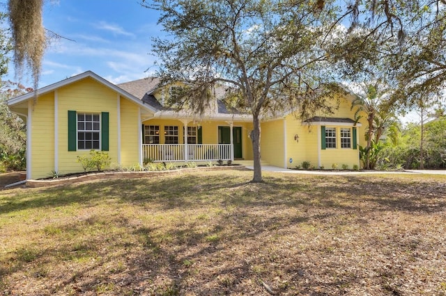 4050 Rock Creek Dr, Port Charlotte, FL 33948 - ranch-style house featuring covered porch and a front lawn