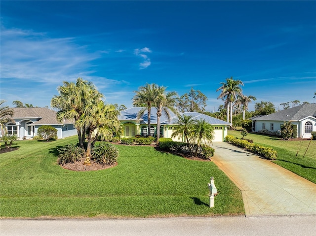 ranch-style home with a garage, concrete driveway, and a front yard