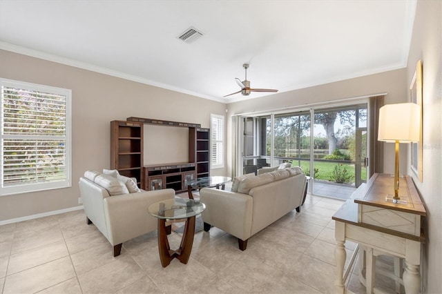 living room featuring light tile patterned floors, visible vents, ornamental molding, a ceiling fan, and baseboards