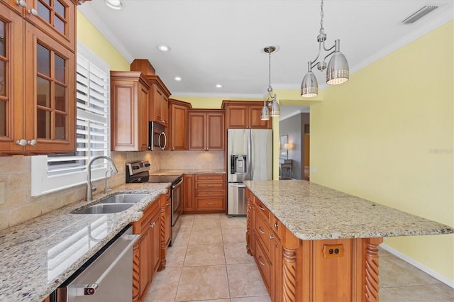 kitchen featuring a kitchen island, glass insert cabinets, appliances with stainless steel finishes, light stone counters, and a sink