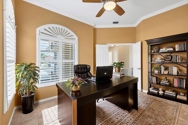 office area with crown molding, light tile patterned floors, visible vents, a ceiling fan, and baseboards