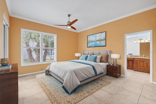 bedroom with light tile patterned floors, ensuite bathroom, a sink, baseboards, and ornamental molding