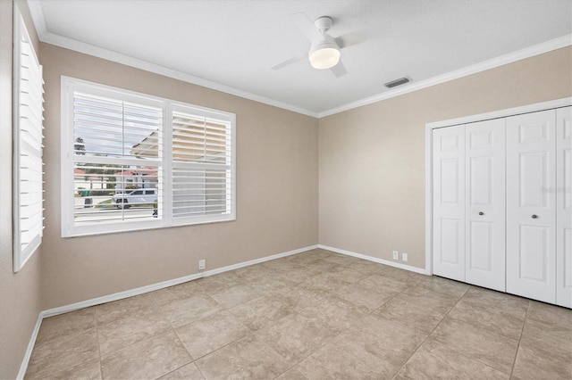 unfurnished bedroom featuring a closet, visible vents, and crown molding