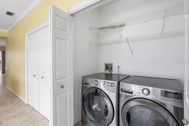 clothes washing area featuring crown molding, visible vents, separate washer and dryer, laundry area, and baseboards