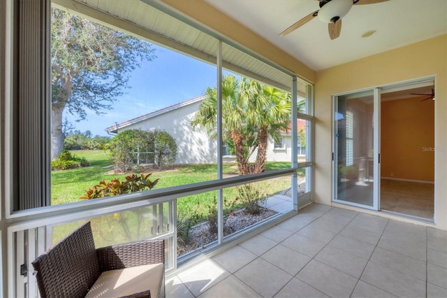 unfurnished sunroom featuring ceiling fan