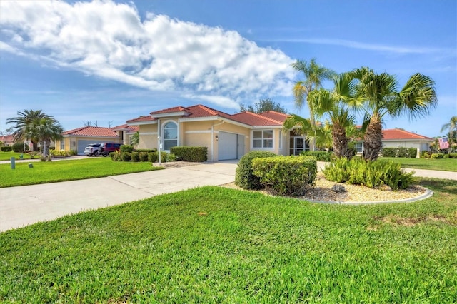 mediterranean / spanish-style home with an attached garage, a front lawn, concrete driveway, and stucco siding