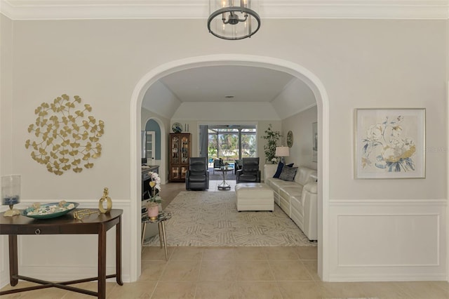 living area with a wainscoted wall and crown molding