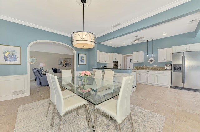 dining room featuring visible vents, arched walkways, crown molding, and light tile patterned flooring