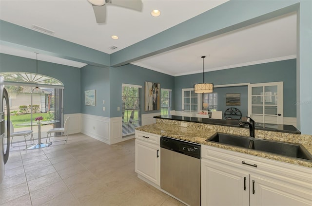 kitchen with a wainscoted wall, decorative light fixtures, visible vents, stainless steel dishwasher, and a sink