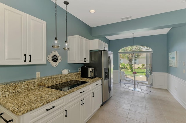 kitchen featuring black electric cooktop, visible vents, white cabinetry, hanging light fixtures, and light stone countertops