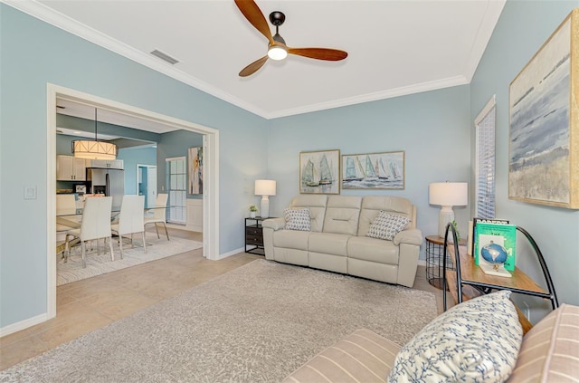 living area with baseboards, visible vents, ceiling fan, ornamental molding, and light tile patterned flooring