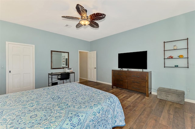 bedroom with dark wood-type flooring, a ceiling fan, visible vents, and baseboards