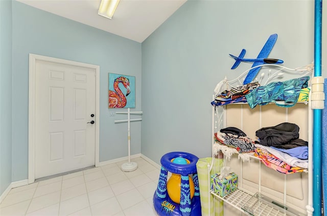 tiled foyer featuring baseboards