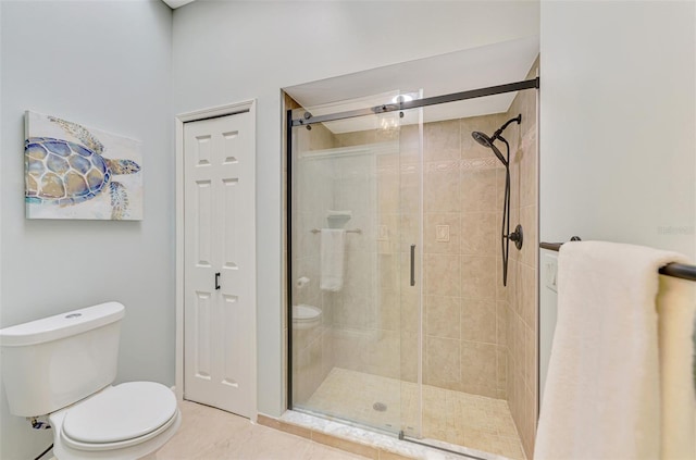 full bath featuring toilet, a shower stall, and tile patterned floors