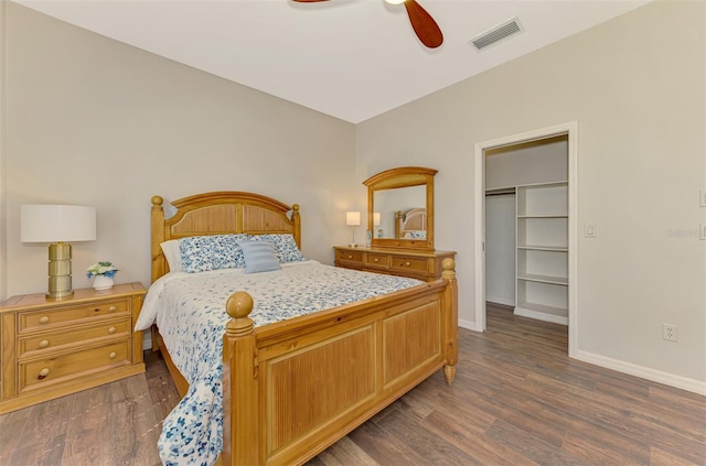 bedroom with dark wood-style floors, baseboards, visible vents, and ceiling fan