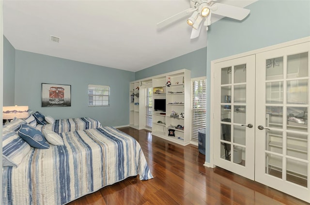 bedroom with dark wood-style flooring, french doors, visible vents, a ceiling fan, and baseboards