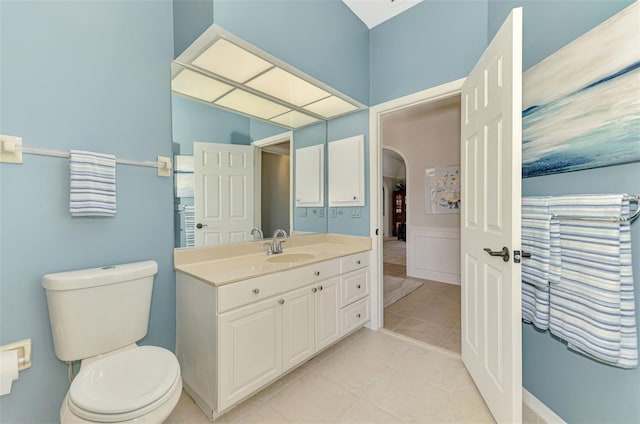 bathroom with tile patterned flooring, vanity, and toilet