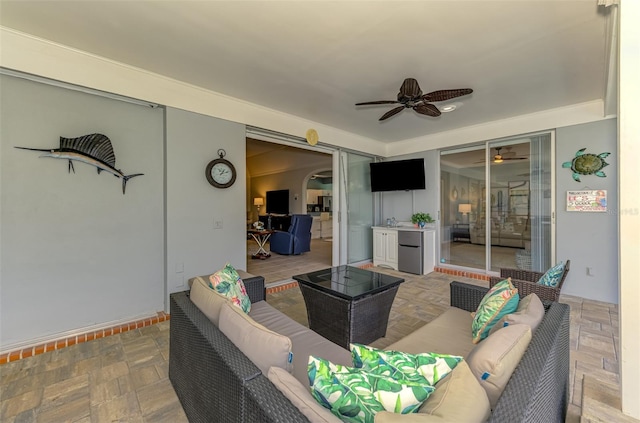 living area featuring a ceiling fan