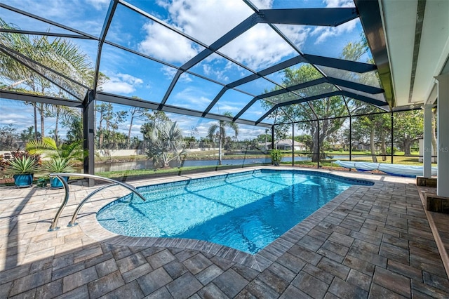 outdoor pool featuring glass enclosure and a patio