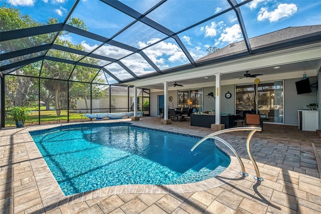 outdoor pool featuring a ceiling fan, a lanai, a patio, and an outdoor hangout area