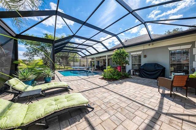 exterior space with a lanai, a patio area, ceiling fan, and grilling area