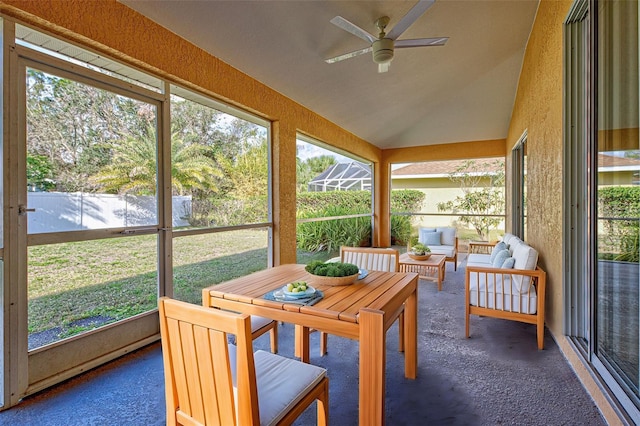 sunroom / solarium featuring lofted ceiling and ceiling fan