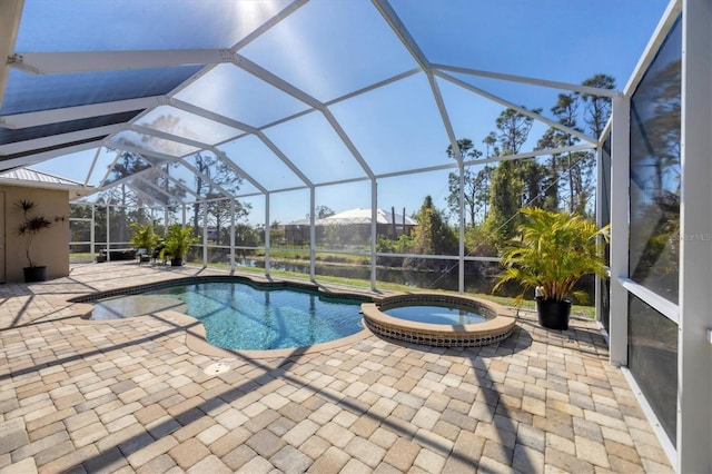 view of pool with a pool with connected hot tub, glass enclosure, and a patio