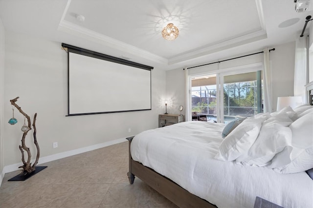 bedroom with crown molding, a tray ceiling, and access to exterior