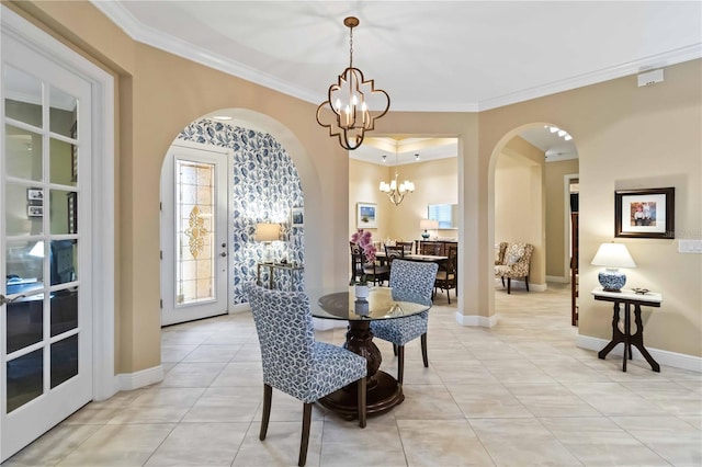 dining area featuring light tile patterned floors, baseboards, arched walkways, ornamental molding, and a chandelier