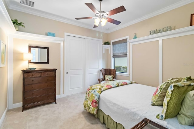 bedroom with ornamental molding, a closet, visible vents, and light carpet