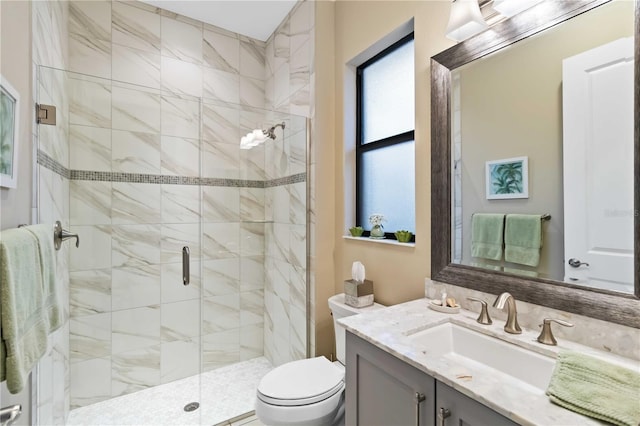 full bath featuring vanity, a shower stall, and toilet