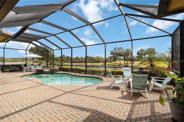 view of pool with outdoor dining space, a pool with connected hot tub, glass enclosure, and a patio