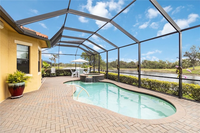 view of pool featuring a pool with connected hot tub, a lanai, and a patio